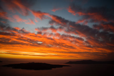 Scenic view of dramatic sky over sea during sunset