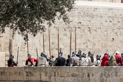 Medieval soldiers laying siege to a castle