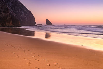 Scenic view of beach at sunset