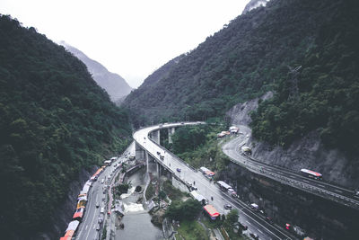High angle view of vehicles on road amidst mountains
