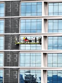 People working by modern building