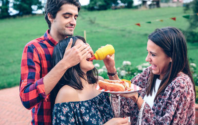 Friends having leisure time together at backyard