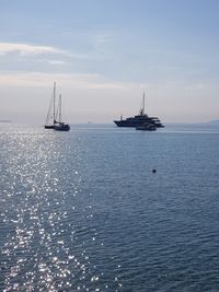 Sailboat sailing on sea against sky