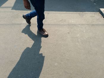 Low section of man walking on street