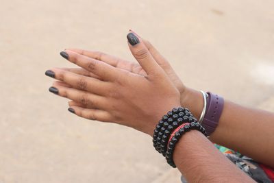 Close-up of woman with hands clasped