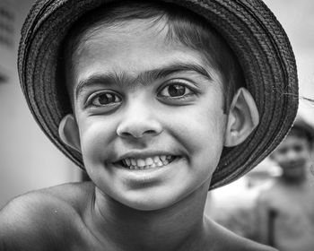 Close-up portrait of smiling boy wearing hat