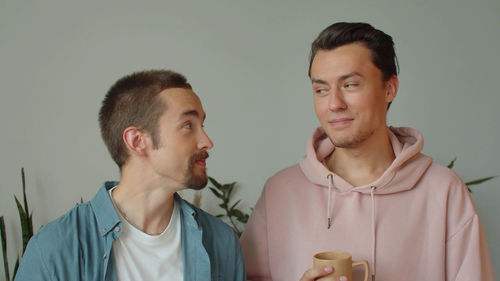 Smiling gay couple at home