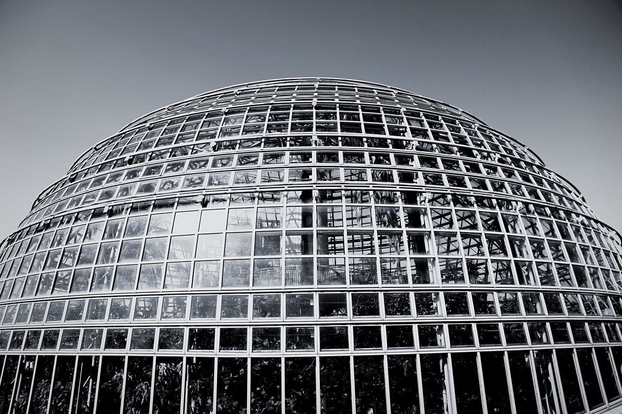 low angle view, architecture, built structure, building exterior, tall - high, modern, pattern, clear sky, skyscraper, office building, tower, glass - material, city, sky, repetition, day, architectural feature, tall, building, design