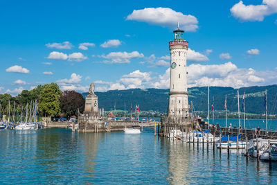 View of lighthouse by sea against sky