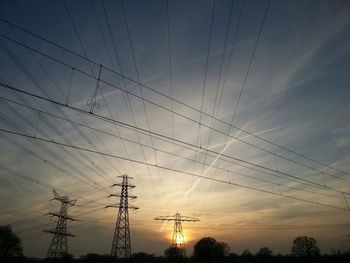 Low angle view of electricity pylon against sky