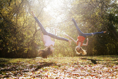 Friends backfliping at field