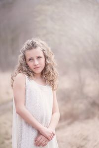 Portrait of smiling girl standing on land