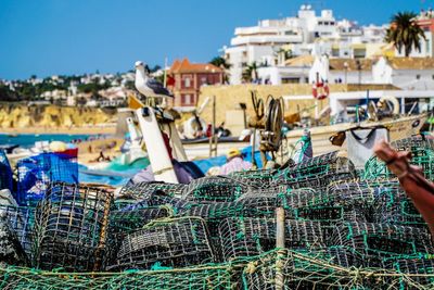 Fishing net at harbor against buildings in city