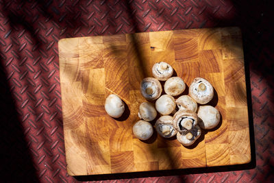 High angle view of mushrooms on cutting board over sheet metal