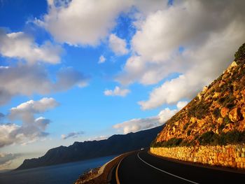 Panoramic view of road amidst mountains against sky