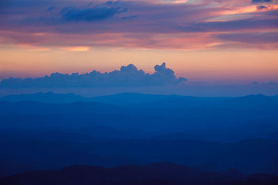 Scenic view of silhouette mountains against sky during sunset