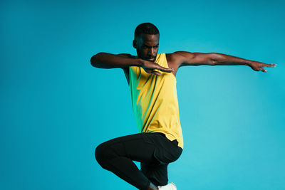 Man running against blue background