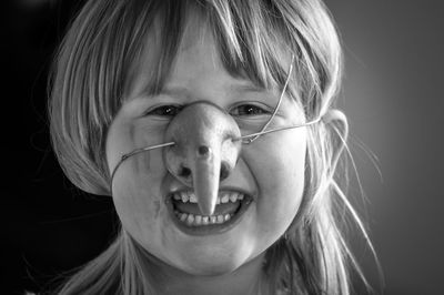 Close-up portrait of a girl wearing witch's nose