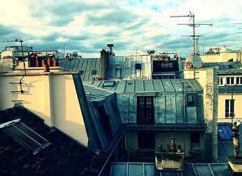 Buildings against cloudy sky