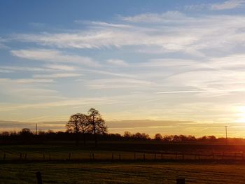 Scenic view of field against sky during sunset