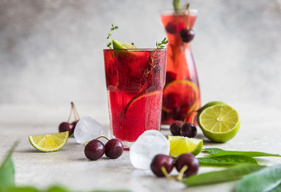 Lemonade or non-alcohol cocktail with cherry and lime