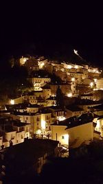 Aerial view of city lit up at night