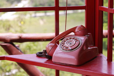 Close-up of old telephone booth on table