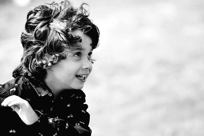 Close-up of smiling cute boy looking up