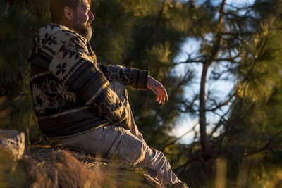 Man looking away sitting outdoors