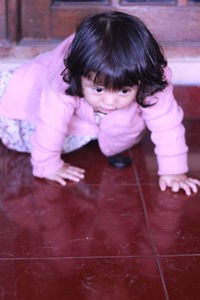 High angle view of girl playing on floor