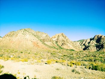 Scenic view of rocky mountains against clear blue sky