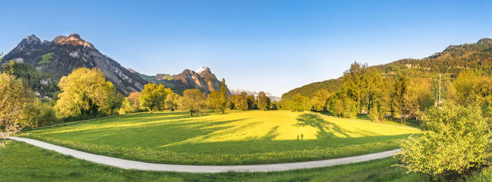 Panoramic view of golf course against clear sky