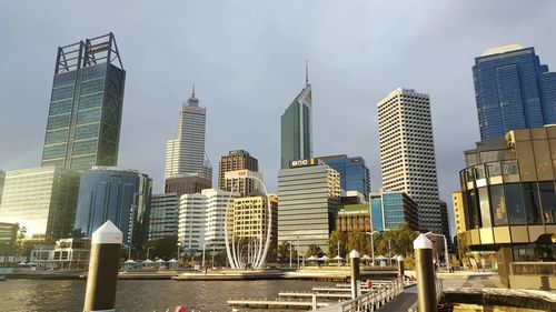 Skyscrapers in front of cityscape against sky