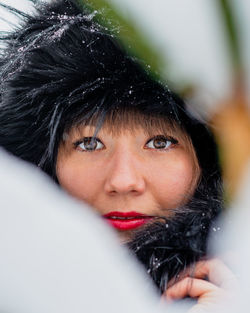 Close-up portrait of woman with snow