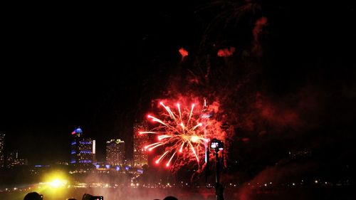 Low angle view of firework display at night