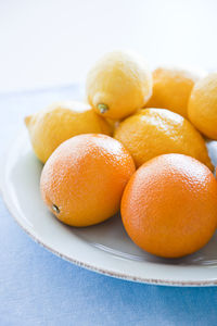 Oranges and lemons on plate