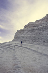 Man on mountain road against sky