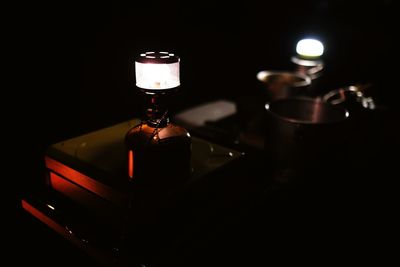 Close-up of illuminated lamp on table