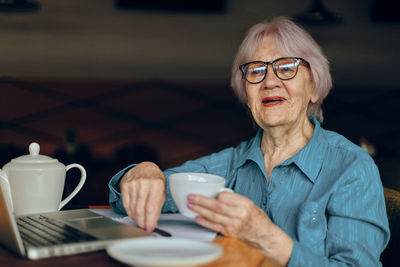 Senior woman having coffee in cafe
