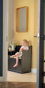 Young woman washing hands in bathroom