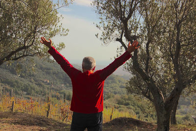 Rear view of person standing by tree