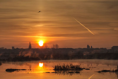 Scenic view of sunset over lake