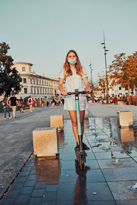 Full length portrait of woman in city