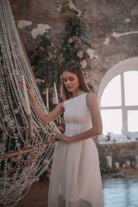 Young woman standing at home