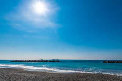 Scenic view of sea against sky on sunny day