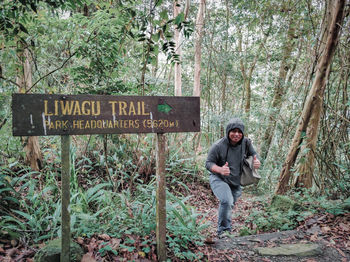 Full length of woman standing in forest