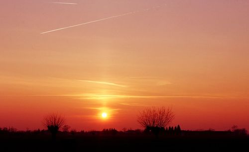 Scenic view of silhouette landscape against romantic sky at sunset