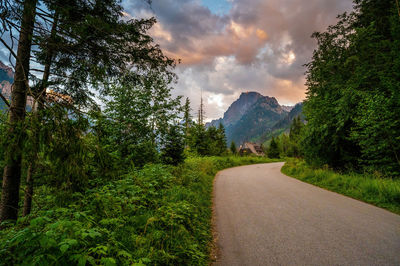 Turning road to the morskie oko against tatra mountains during dramatic sunset or sunrise