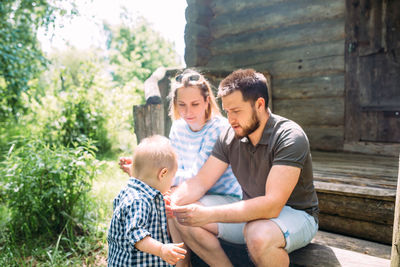 Mom, dad and little son spend time together in the summer outdoors