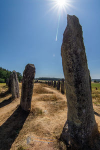 Stone wall on field against sky